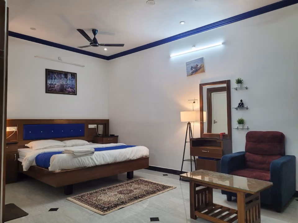 Family suite with king bed, seating area and dresser