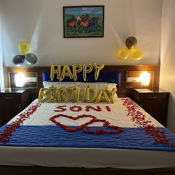 Birthday decoration with balloons and rose-petal heart at Nivaa Stays