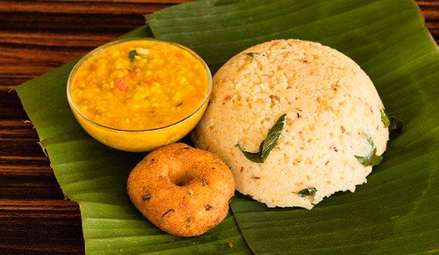 Fresh pongal with vada served on banana leaf
