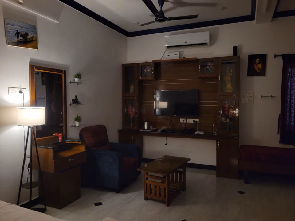 Living room with warm evening lighting at Nivaa Stays